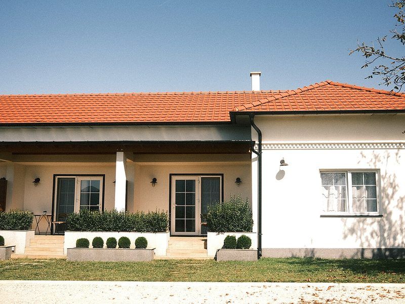 A house with a tiled roof and a front garden